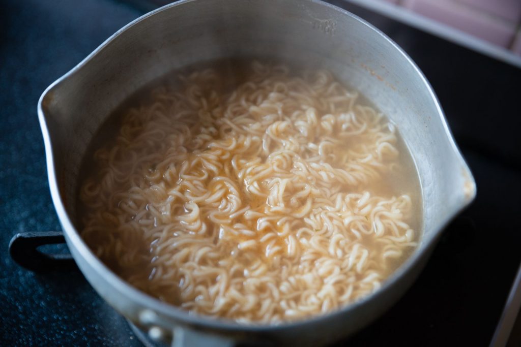 鍋でインスタントラーメンを作る様子